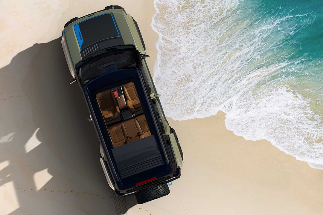 Aerial view of Jeep EV Recon 2024 on beach with sea