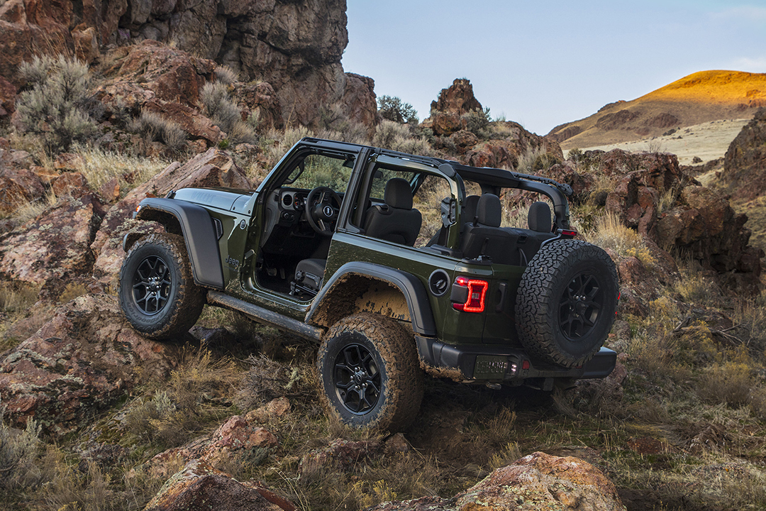 Rear side view of Jeep Wrangler 2024 climbing a steep hill