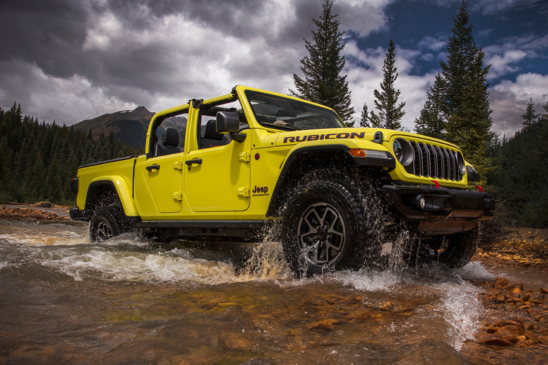 Side view of Jeep Gladiator 2024 crossing a river